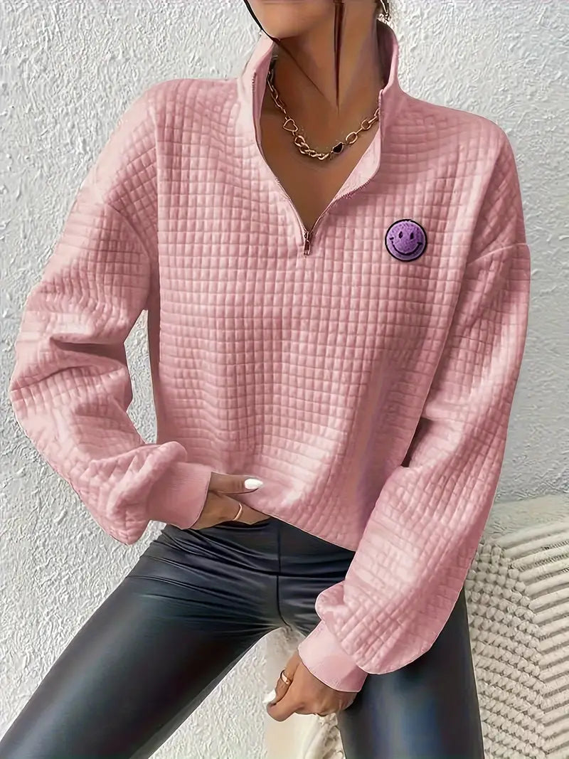 comfortabele en losse sweater met een effen glimlachende smiley